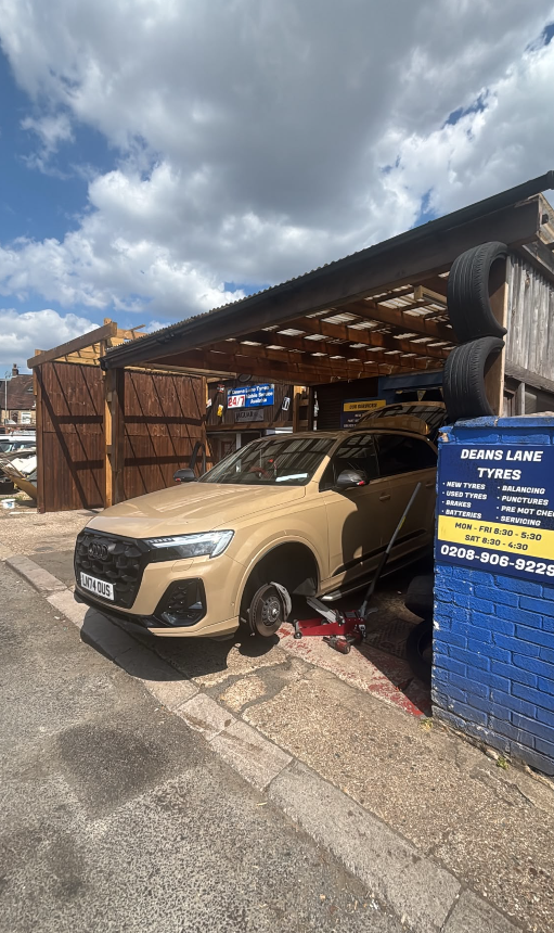 Audi SUV jacked up in the fitting bay for a wheel change