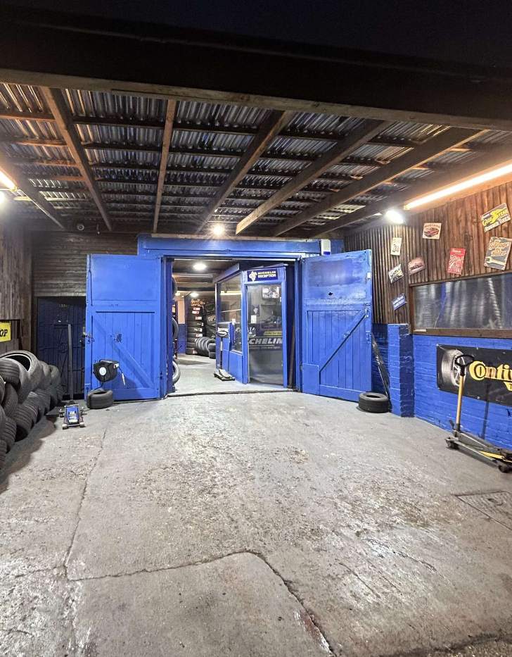 Blue workshop doors and reception at Deans Lane Tyres